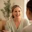 Shahrin Strouts speaking with a guest in a calm wellness studio